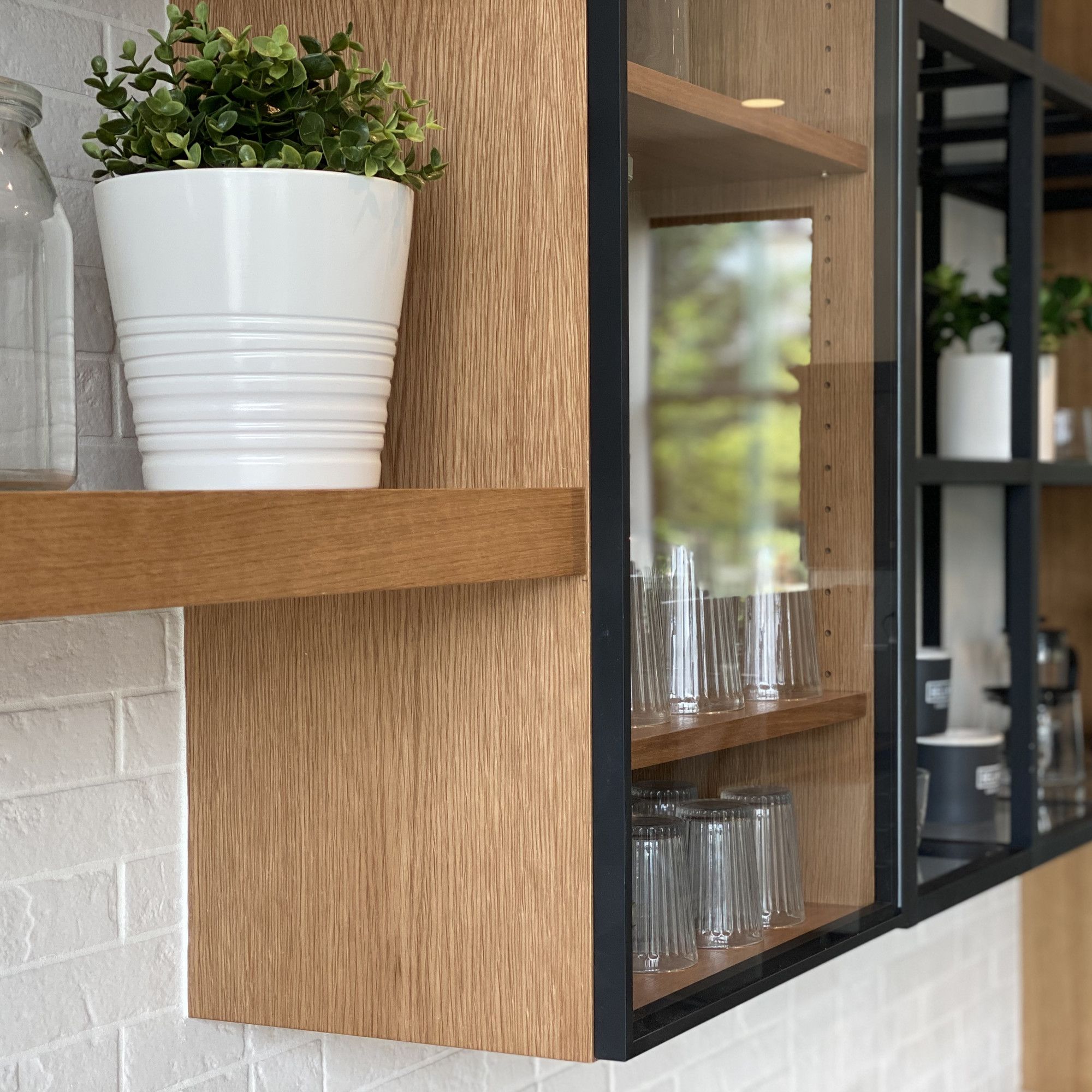 Modern wood kitchen cabinets with black trim and glass fronts