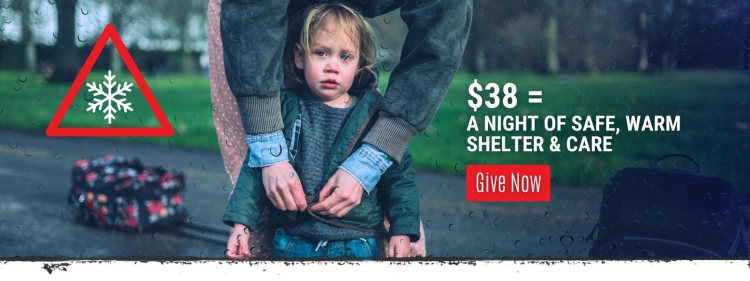 Child standing in the rain with an adult zipping up child's coat, highlighting Vine Maple Place's plea for shelter and warmth during cold weather. Text overlay reads: '$38 = A night of safe, warm shelter & care.' Call-to-action button says 'Give Now.'