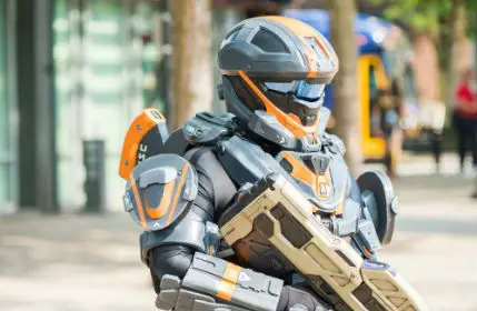 Cosplayer in full armor space suit with space gun