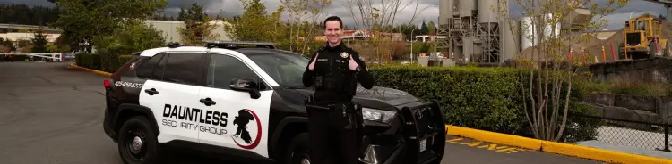 Patrol officer standing in front of their vehicle in full gear.