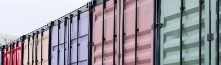 Colorful shipping containers side by side in an angled line.