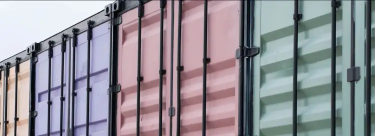 Colorful shipping containers side by side in an angled line.