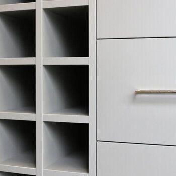Closeup of grey cabinet drawers with silver handles