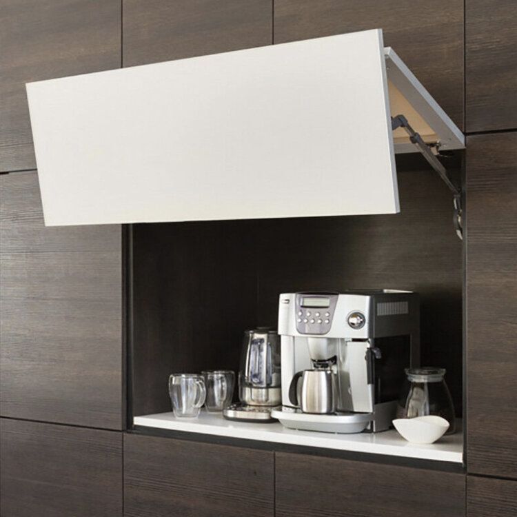Dark wood siding with a cabinet that flips open upwards to reveal an expresso machine and cups