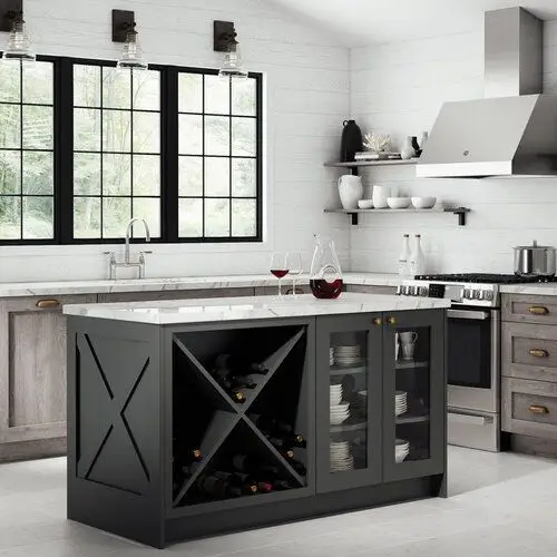 Kitchen with black island with cabinets and wine storage. Cabinets have glass fronts. Whitewood drop with white marble countertops and purple-brown wood cabinets with copper handles.