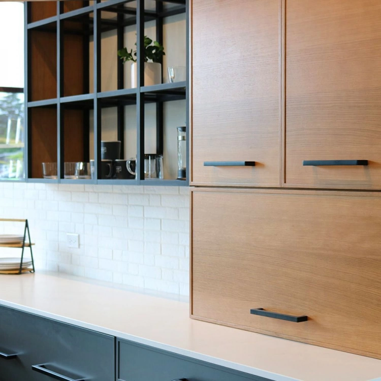 Close up of kitchen cabinets and countertop. Lower cabinets are wood, upper cabinets are white and the countertop is a grey silver stone. There are small middle cabinets with light green doors. 