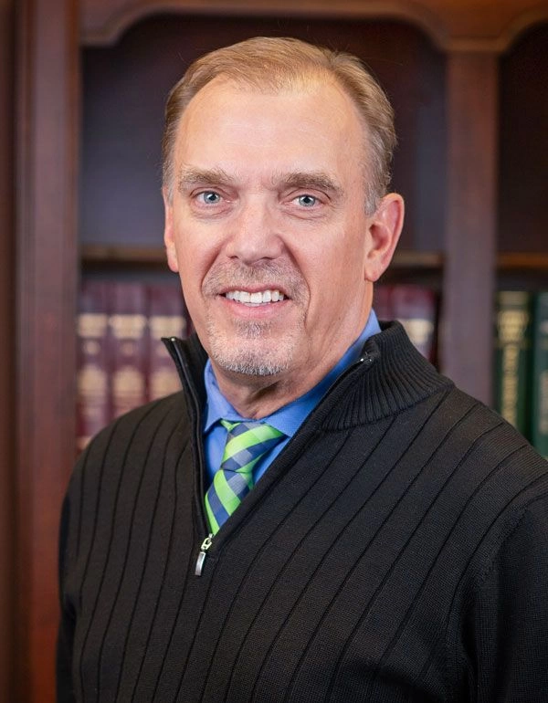 Portrait photo of Ed Harper, Personal Injury attorney, in a business suit. 